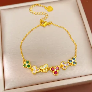 Close-up of elegant gold flower bracelet featuring vibrant colorful zircon stones