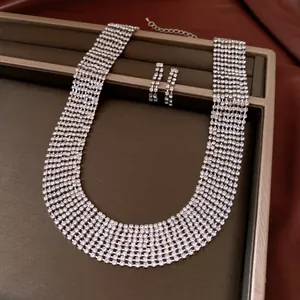 Detail view of multi-row rhinestone choker necklace and earring set on jewelry tray.