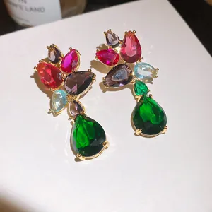 Macro view of luxurious teardrop zircon earrings featuring vibrant colorful gemstones