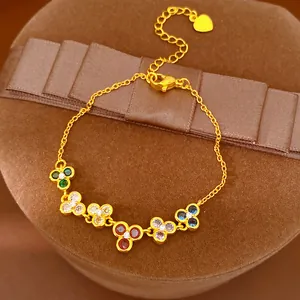 Detailed view of a gold-plated bracelet with multi-colored zircon flower charms.