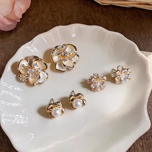Elegant French vintage gold pearl flower stud earrings with shimmering zircons set