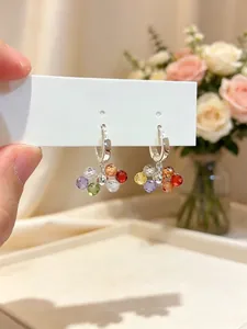 Detailed close-up of colorful glass bead tassel earrings with silver-toned hoops