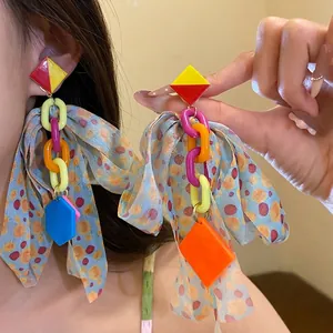 Vibrant acrylic chain earrings featuring a large polka dot pattern fabric bow for women