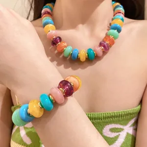 Vibrant acrylic beaded necklace and bracelet set with gold spacers for a summer vacation look.