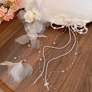Elegant white pearl bow hair clip with long tassels and grey tulle flower accessory