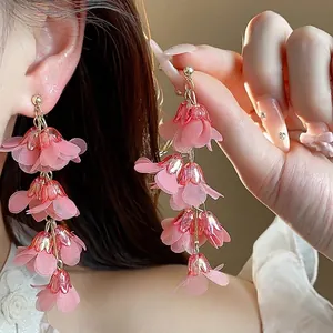 Elegant pink chiffon flower tassel earrings with acrylic details for a stylish look.