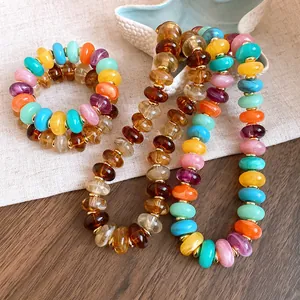 Detailed view of colorful marbled acrylic beads on a summer style necklace and bracelet set