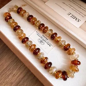 Detailed macro view of retro amber-tone acrylic swirl bead necklace in jewelry box