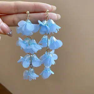 Detail view of light blue chiffon flower tassel earrings with soft petals
