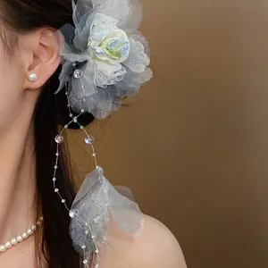 Elegant gray mesh floral hair clip with pearl tassel dangles shown on a model's hair
