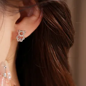 Detailed macro view of a silver bear stud earring featuring sparkling zircon pavé setting