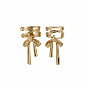 Elegant gold-tone bow knot ear cuffs for non-pierced ears, minimalist fashion design.