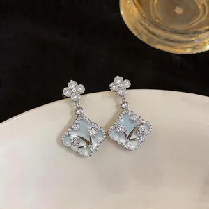 Elegant silver needle earrings with floral mother of pearl and sparkling zircons