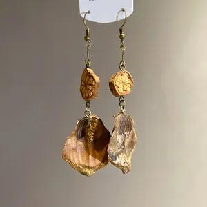 Close-up of vintage handmade wooden drop earrings with natural organic textures