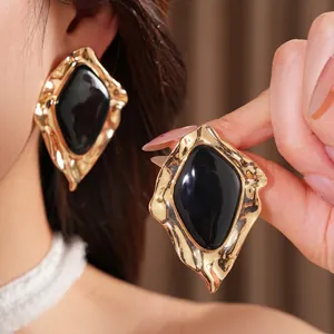 Geometric irregular gold earrings with black resin inlay for a bold stylish look