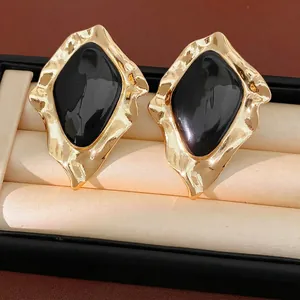 Elegant gold-tone irregular geometric stud earrings with black drip oil finish