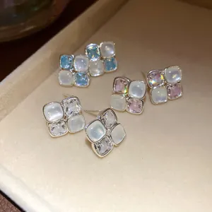 Close-up of elegant vintage square stud earrings with zircon and resin in a jewelry tray