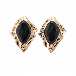 Chic exaggerated irregular gold-framed stud earrings with black geometric stone inlay