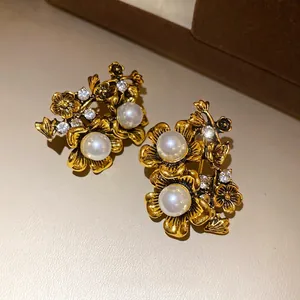 Vintage gold flower stud earrings with pearls and rhinestones, elegant retro style