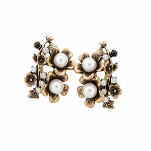 Elegant vintage flower stud earrings with white pearls and sparkling rhinestones