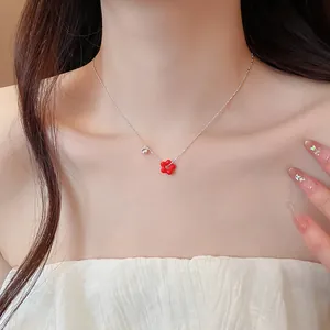 Detail shot of a red flower necklace with zircon on an elegant neckline