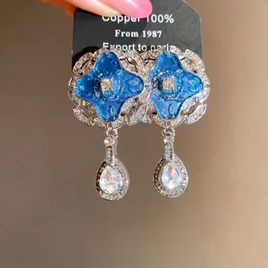Vintage palace style drop earrings with blue enamel and clear sparkling rhinestones