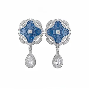 Luxurious vintage court style earrings featuring blue enamel and teardrop crystal pendants