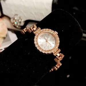 Elegant vintage rose gold watch with crystal flower bezel on black velvet