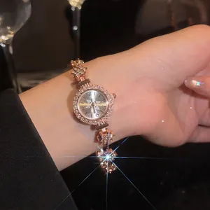 Elegant vintage gold-tone flower bracelet watch for women featuring sparkling rhinestones
