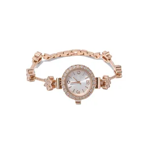Elegant rose gold bracelet watch for women featuring rhinestone floral accents and vintage dial