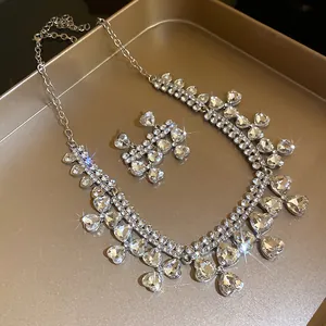 Detailed view of the sparkling silver heart pendant necklace and matching earrings set