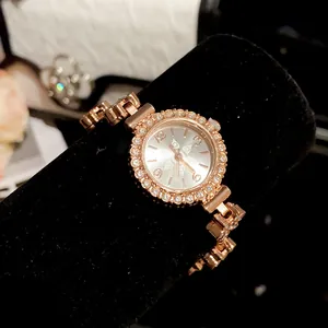 Close-up of vintage gold floral watch with rhinestone bezel and link bracelet
