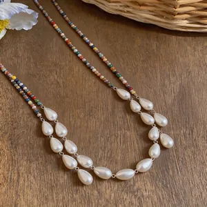 Handmade retro ethnic style necklace featuring colorful beads and elegant teardrop pearls