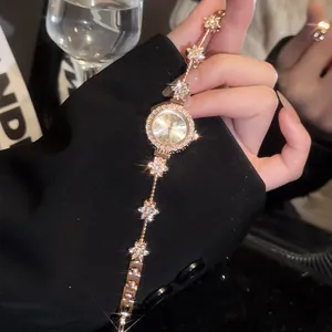 Elegant close-up of a vintage gold flower bracelet watch adorned with full rhinestones
