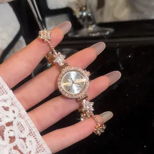 Close-up view of a luxury vintage gold floral watch with a sparkling rhinestone bracelet for women