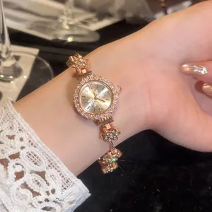 Close-up of vintage gold floral bracelet watch with elegant sparkling diamond accents.