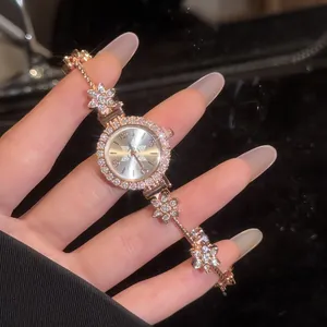 Close-up detail of vintage rose gold flower bracelet watch featuring sparkly crystals