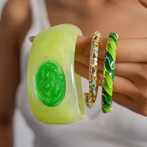 Detailed macro view of colorful enamel dopamine bracelets with geometric and floral patterns