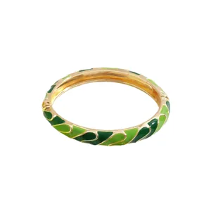 Elegant gold-plated bangle featuring two-tone green enamel geometric wavy dopamine patterns