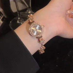 Detailed close-up of a vintage rose gold flower bracelet watch featuring shiny rhinestones