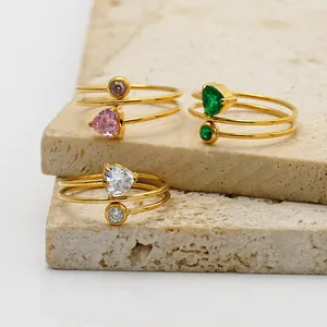 Close-up detail of 18K gold plated wire-wrapped rings featuring heart and round zircons
