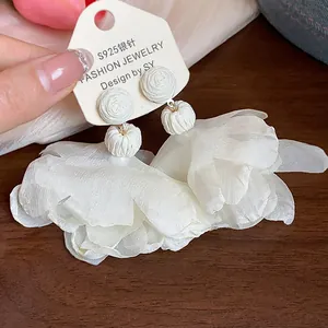 Close-up macro detail of white chiffon flower earrings with S925 silver needle