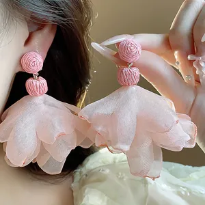 Close-up of pink chiffon flower tassel earrings showing delicate fabric texture