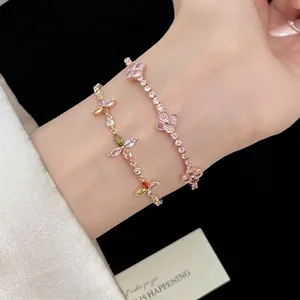 Rose gold pink clover bracelet and multi-color floral zircon bracelet set on a woman's wrist