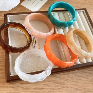 Stylish vibrant marbled resin bangles in irregular wavy geometric design for women.