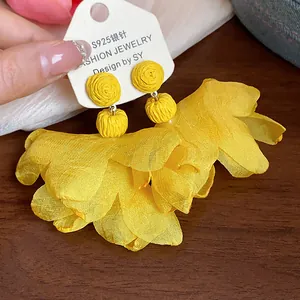 Detailed macro view of vibrant yellow chiffon petal earrings with S925 silver needles