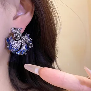 Elegant zircon koi fish stud earrings featuring a vintage silver needle and sparkling blue stones