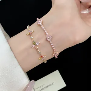 Close-up view of elegant pink and colorful zircon clover adjustable bracelets on wrist