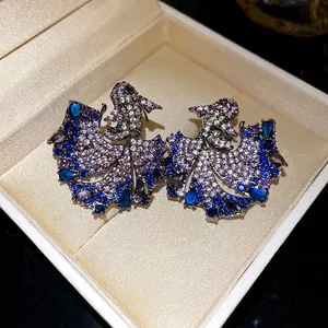 Elegant koi fish stud earrings encrusted with colorful zircons in a vintage luxury style.