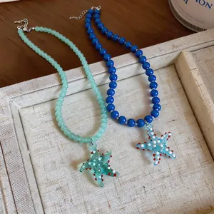 Close-up of beaded starfish necklaces in blue and aqua for a coastal look